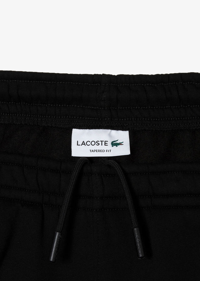 Lacoste Pants  Contrast stripe tracksuit trousers - black 